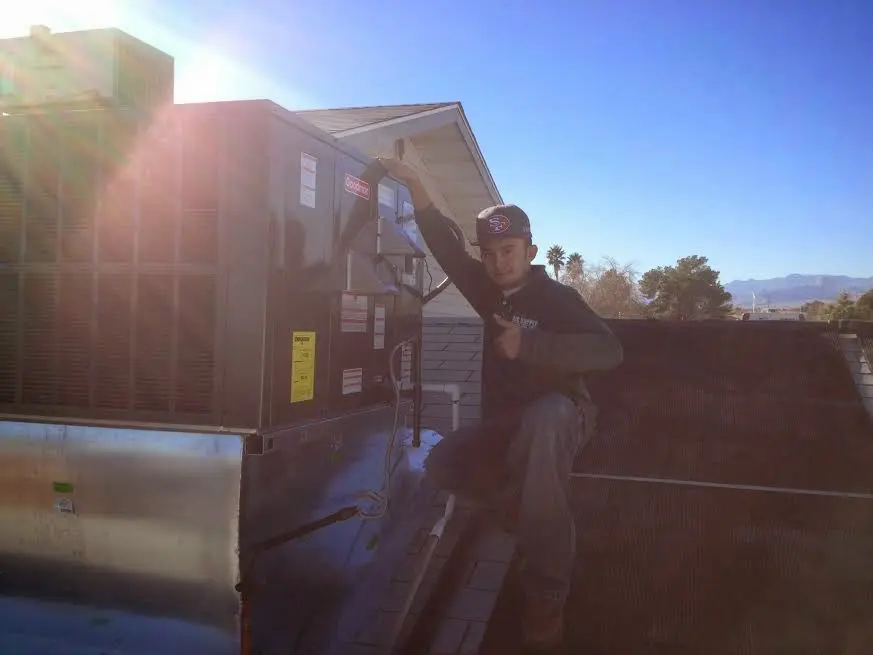 HVAC technician performing AC Tune-Up on a rooftop unit in Lebanon